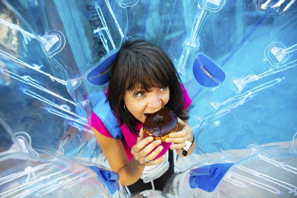 woman eating donut on bubble food tour