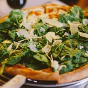 Tommaso’s spinach pizza at table