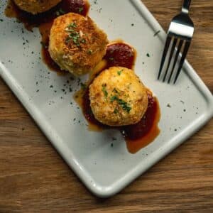 croquettes in sauce on plate served at 15 Romolo