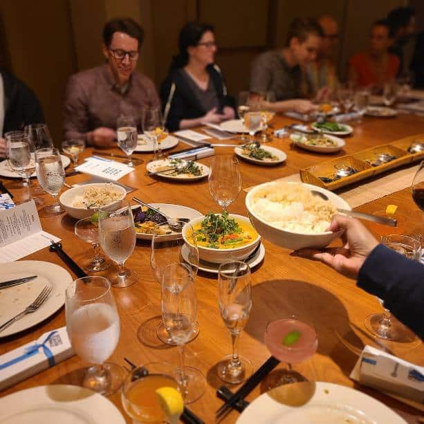 group sitting down for entree during interactive meal