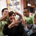 group toasting pisco punch cocktails during north beach food tour