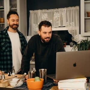 guests looking at screen on virtual happy hour with cocktail kit event