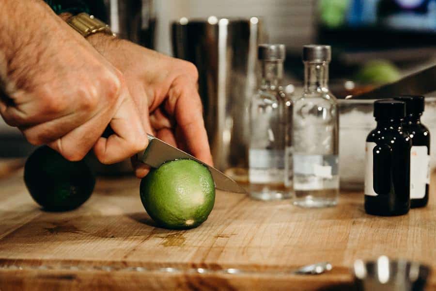 hand cutting limes during virtual mixology class