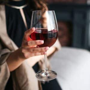 woman holding glass of wine