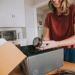 woman opening up snack box during virtual happy hour