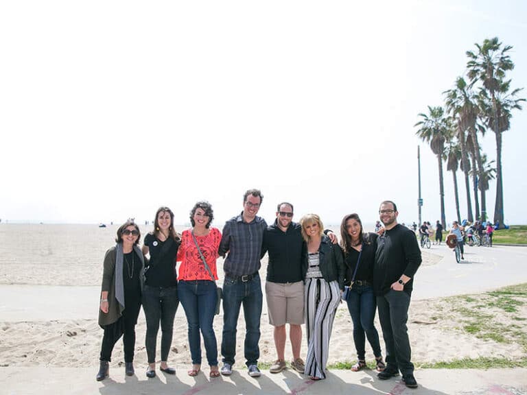 team standing on beach during la corporate team building food tour
