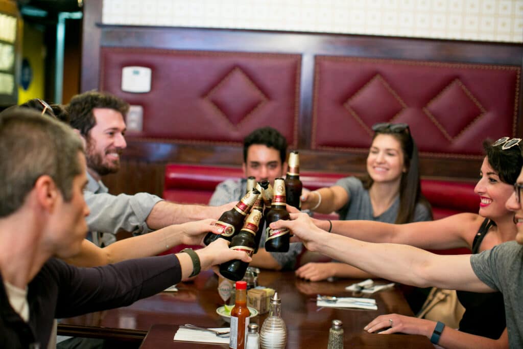 group toasting beers during la birthday party food tour