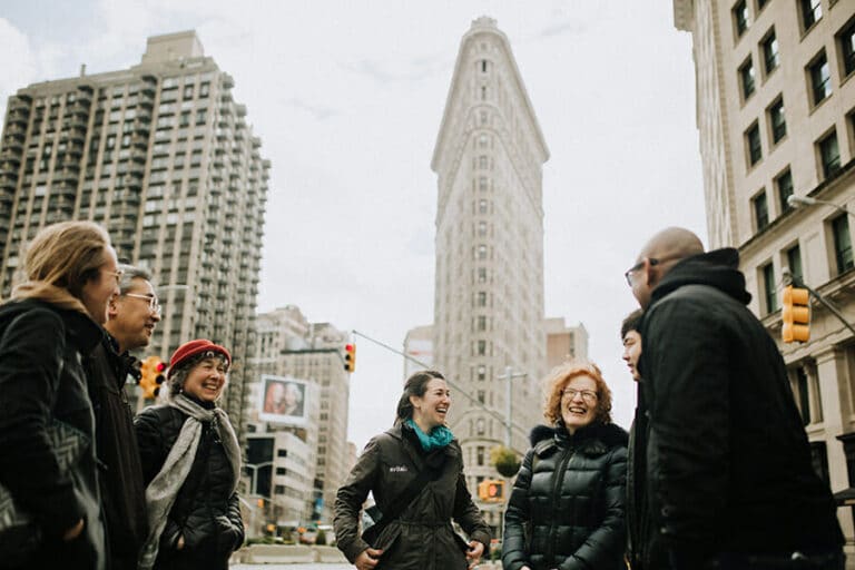 group standing in front of flatiron building during food tour