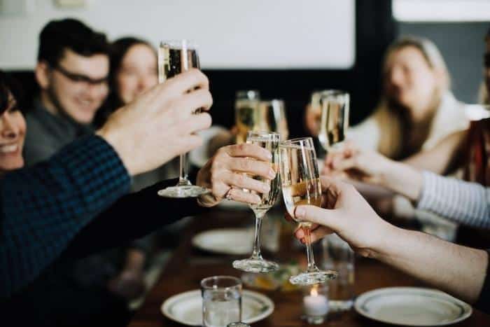 hands toasting champagne during birthday party private dining