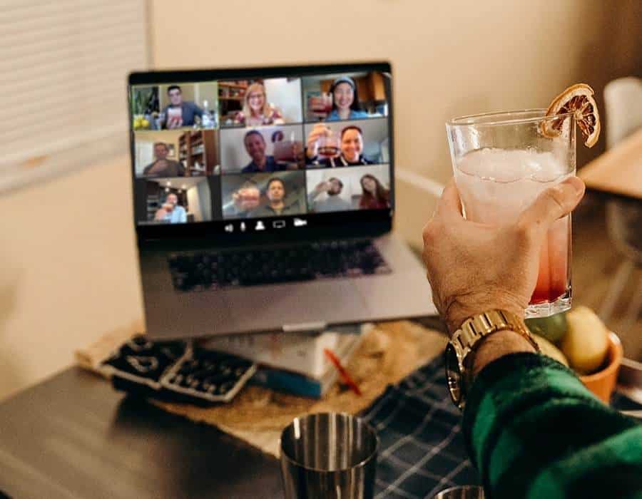 man toasting cocktail during virtual event team building
