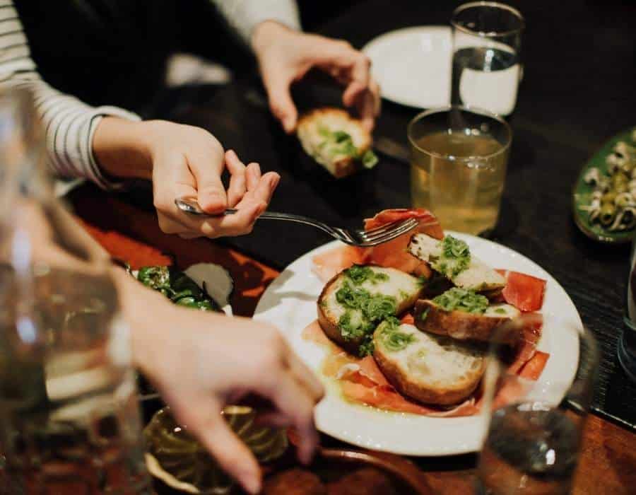 woman eating tapas during nyc food tour