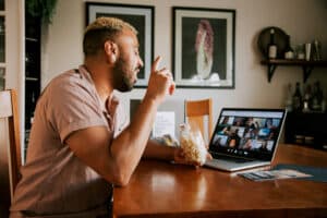 Man talks to participants on computer on a virtual flavor tripping experience