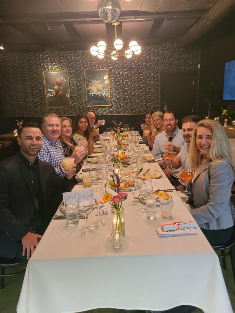 group sitting at table in restaurant during dallas dining experiences