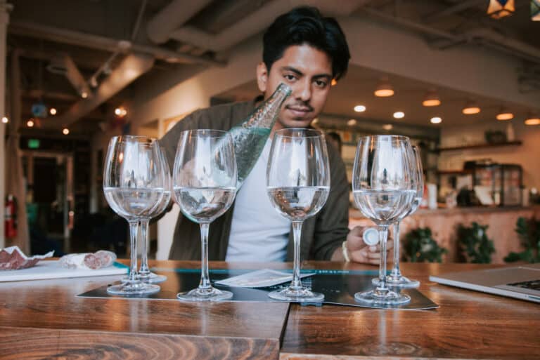 pouring vichy catalan into water glass during virtual water tasting