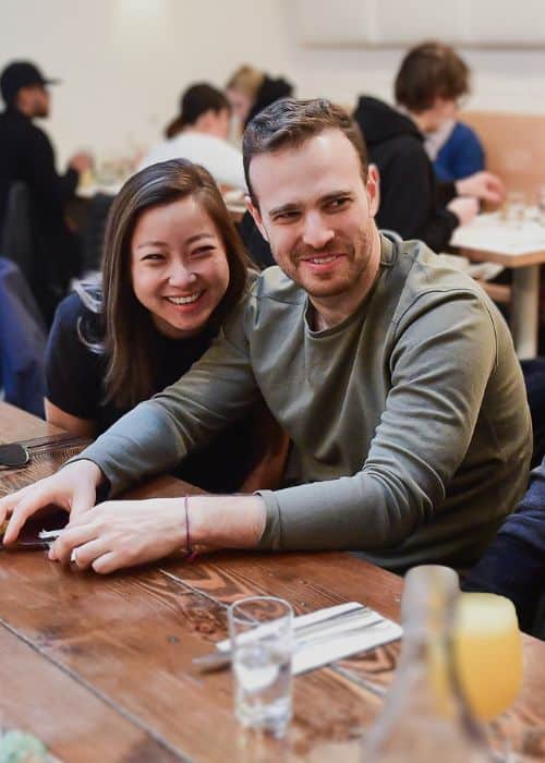 couple sitting and talking at table during nyc date night tour