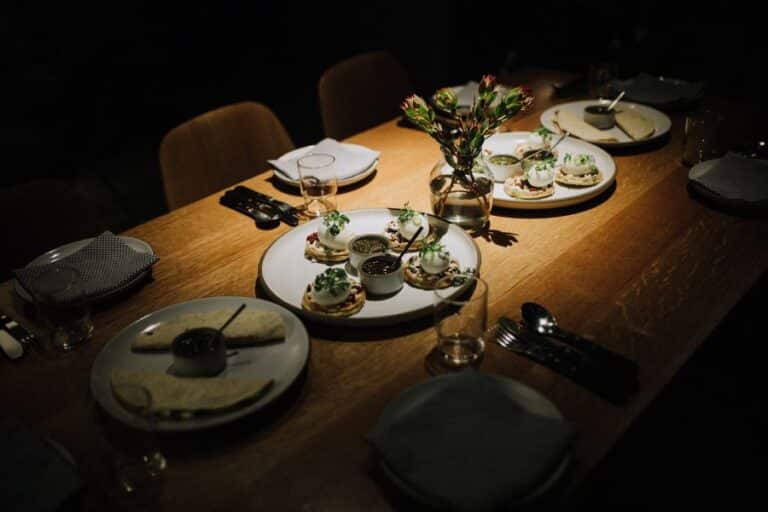 dramatic lighting on restaurant table during michelin food tour