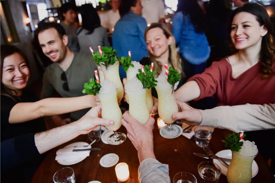 group toasting cocktails and connecting during a dining experience