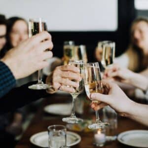 group of hands toasting champagne