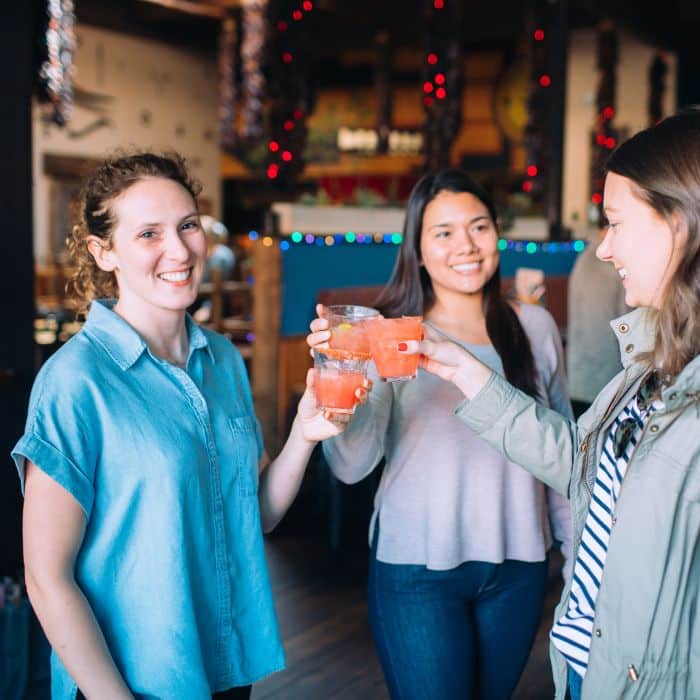 group of women toasting cocktails during bachelorette party food tour in san francisco