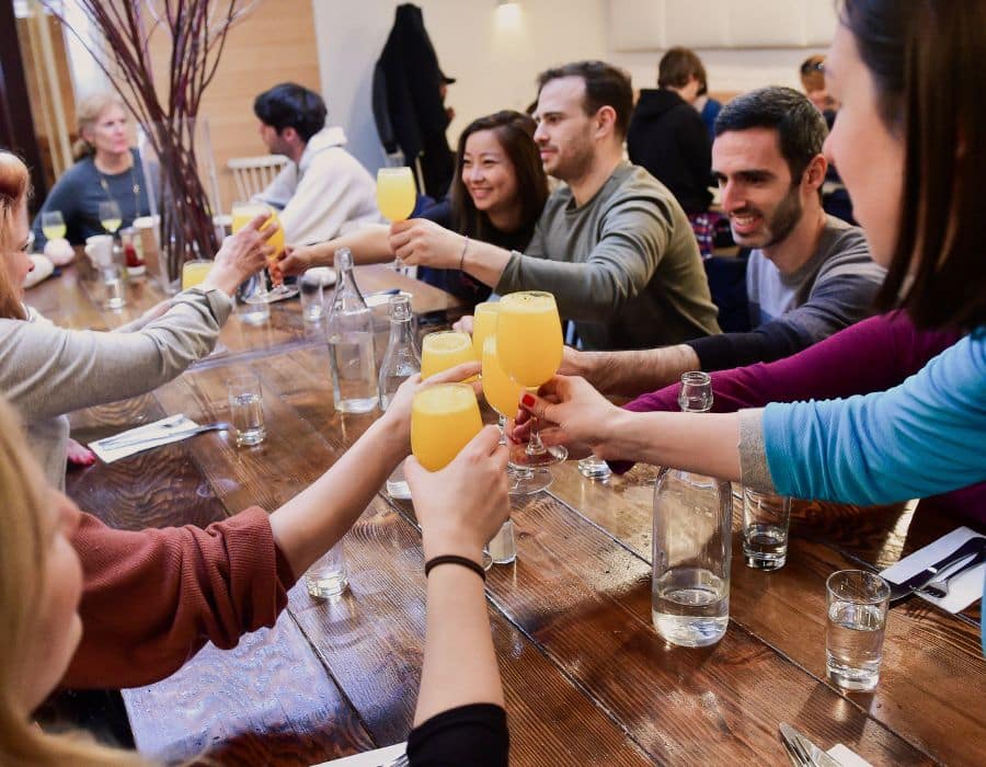 group toasting mimosas during nyc food tour