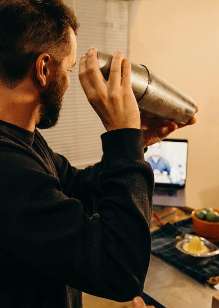 man shaking cocktail during happy hour virtual events