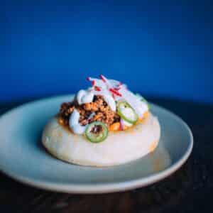 Puffy smoked brisket taco on a plate from West of Pecos restaurant in the Mission District