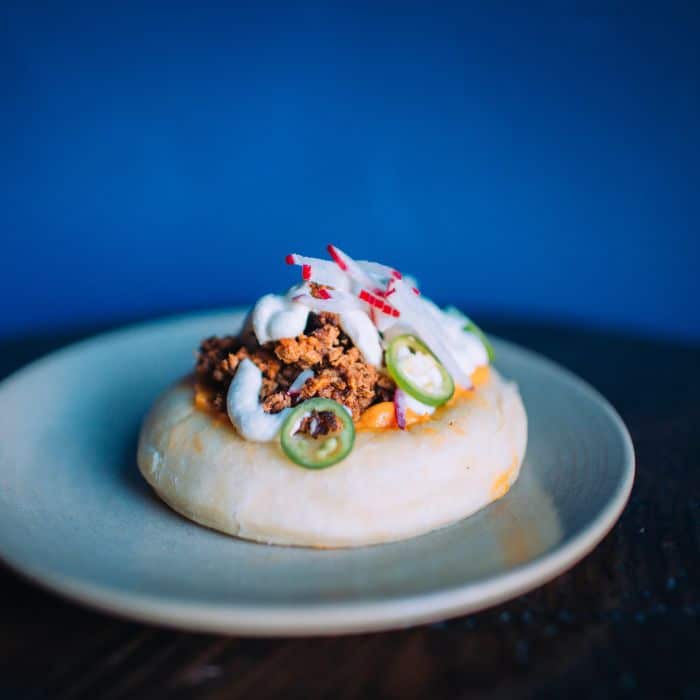 Puffy smoked brisket taco on a plate from West of Pecos restaurant in the Mission District