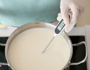 thermometer in pot of goat milk