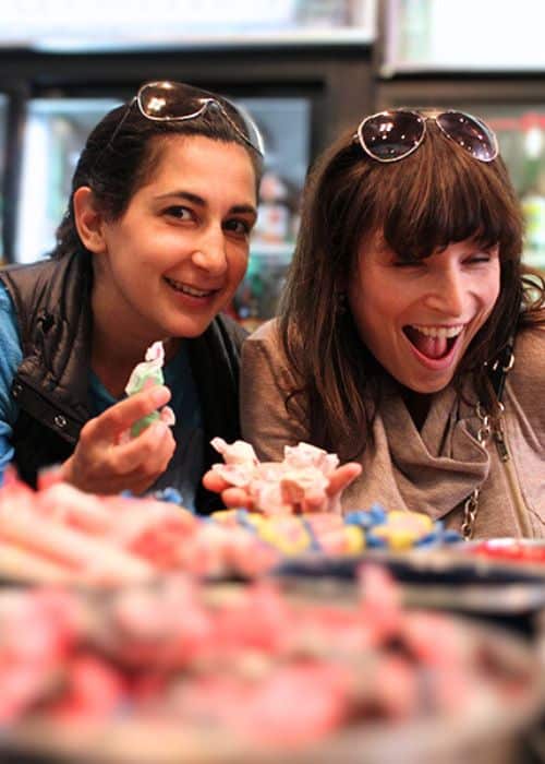 two woman choosing candy during birthday party food tour in san francisco