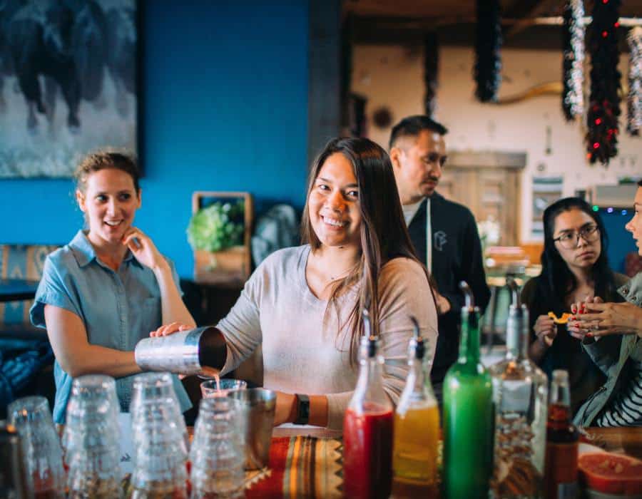woman making cocktail at bar during private dining in san francisco