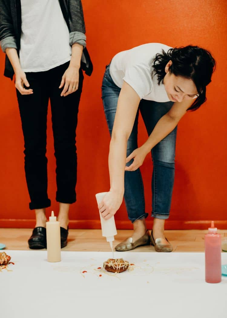 women decorating donut during custom event