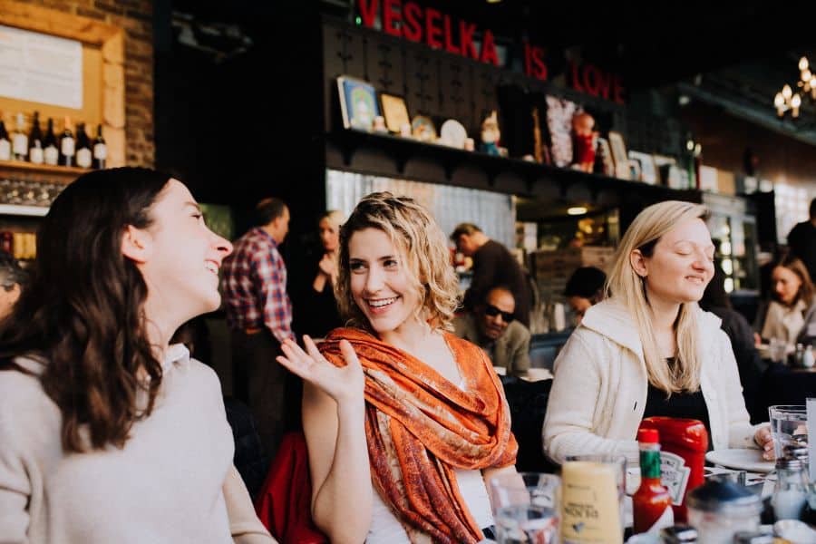 women sitting at restaurant table during nyc birthday party food tour