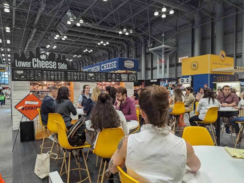 Attendees at Fancy Food Show watching the Charcuterie Chalet Showdown