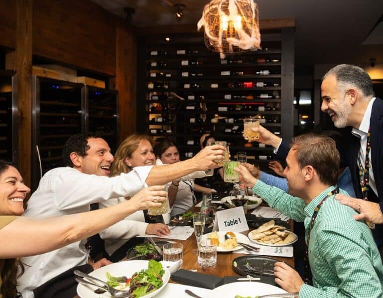 people toasting cocktails and enjoying the best private dining rooms in nyc