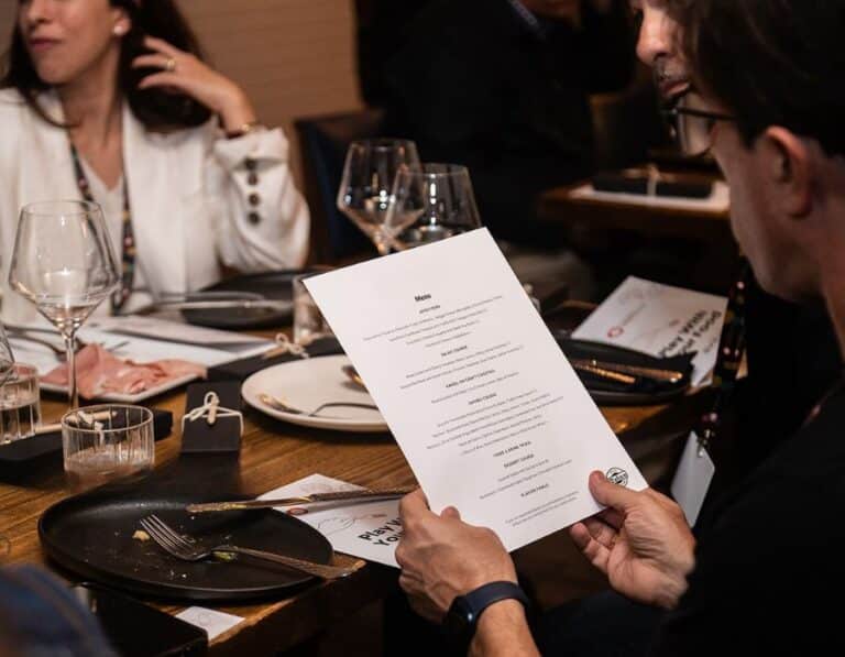 person reading menu during avital private dining experience