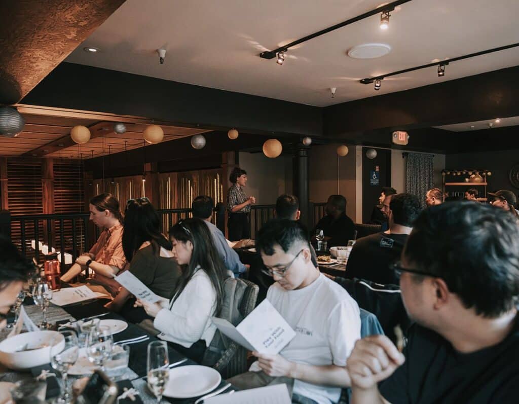 group looking at menus during avital's interactive meal at one of best dc restaurants for large groups