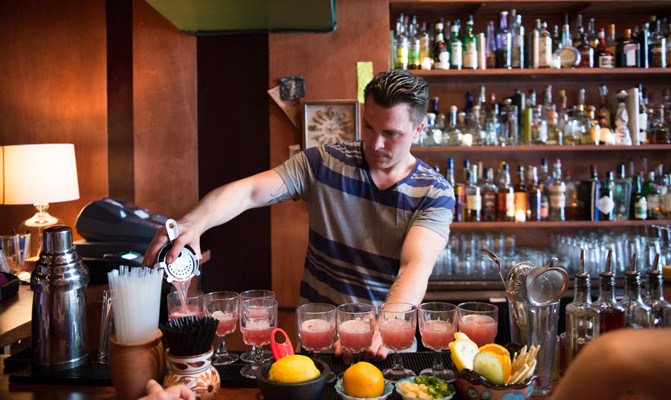 bartender pouring cocktails at bar in San Francisco