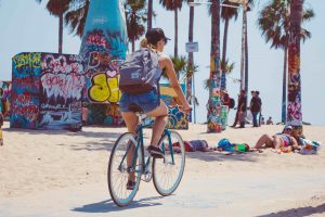 los angeles famous places to visit riding bikes on the venice boardwalk