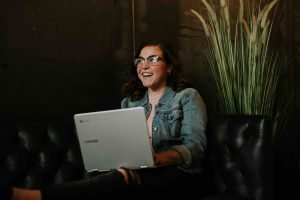 woman on computer during virtual team building