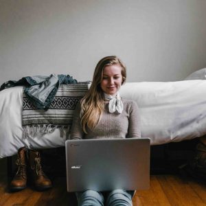 woman on computer during virtual team building