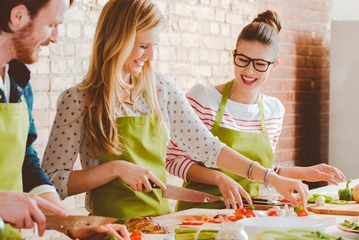 two-women-cooking-at-cutting-board-team-building-activities-in-the-bay-area