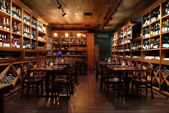private dining room with wine bottles on walls at Barrel Room
