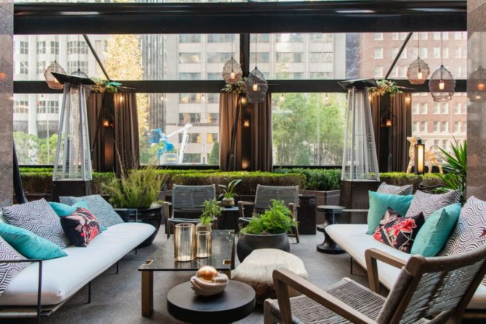 rooftop garden with sofas, tables, and chairs set up for private dining experience