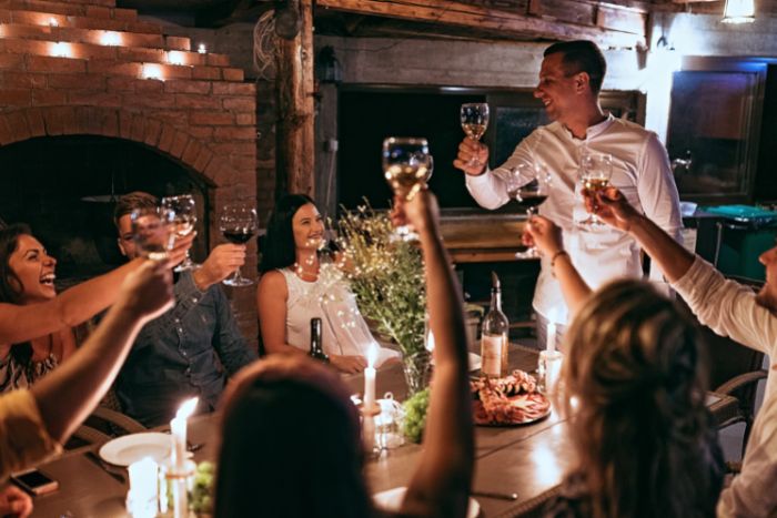 private chef toasting during 50th birthday party dinner