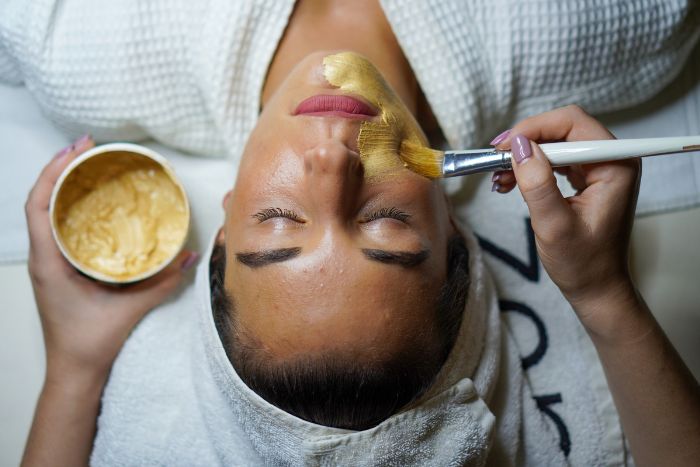 woman-getting-facial-mask-during-spa-day-for-50th-birthday