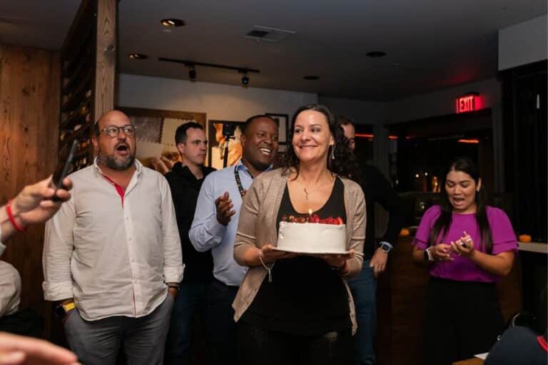 woman holding birthday cake during avital's interactive meal