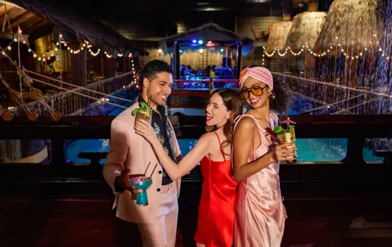 Friends dance with tropical drinks at the Tonga Room and Hurricane Bar
