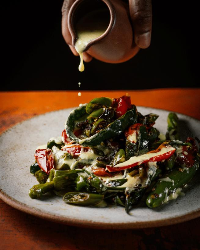 sauce being poured over dish at besharam restaurant in san francisco