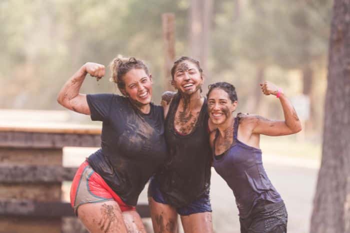 three women posing for camera after fun run, a healthy team building activity for dry january