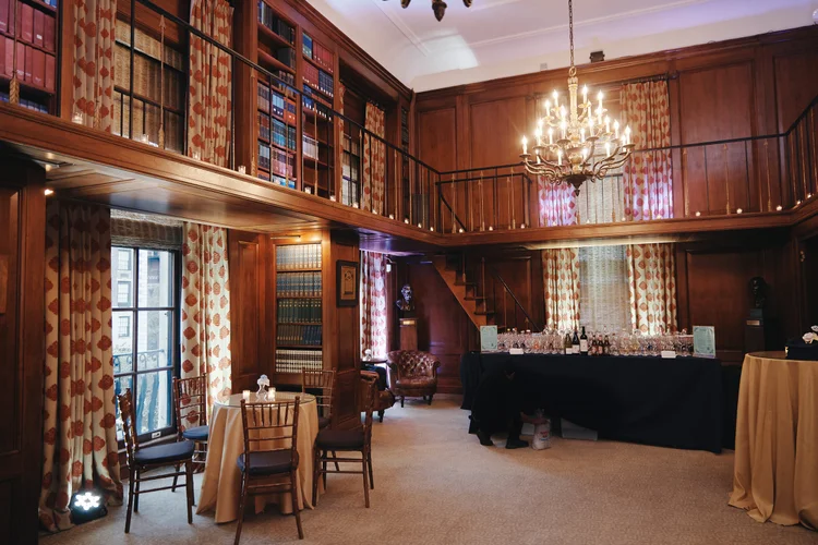 The venue at the Harold Pratt House & Peterson Hall has high ceilings, wood walls, and a big chandelier